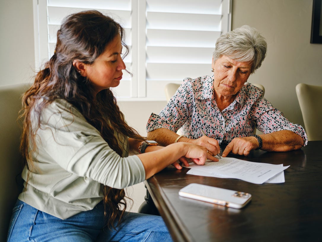 Daughter helping older mother with paperwork