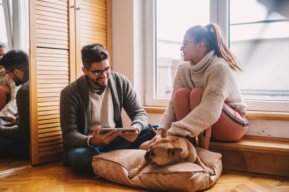 Couple playing with a dog