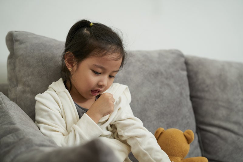 Unwell girl coughing from sore throat